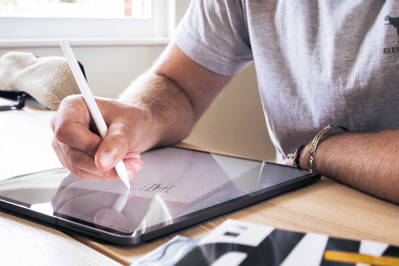 man drawing on ipad